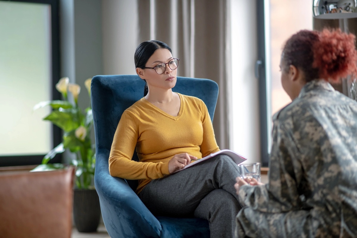 Trauma Informed Therapy: Female therapist listening to woman in military uniform