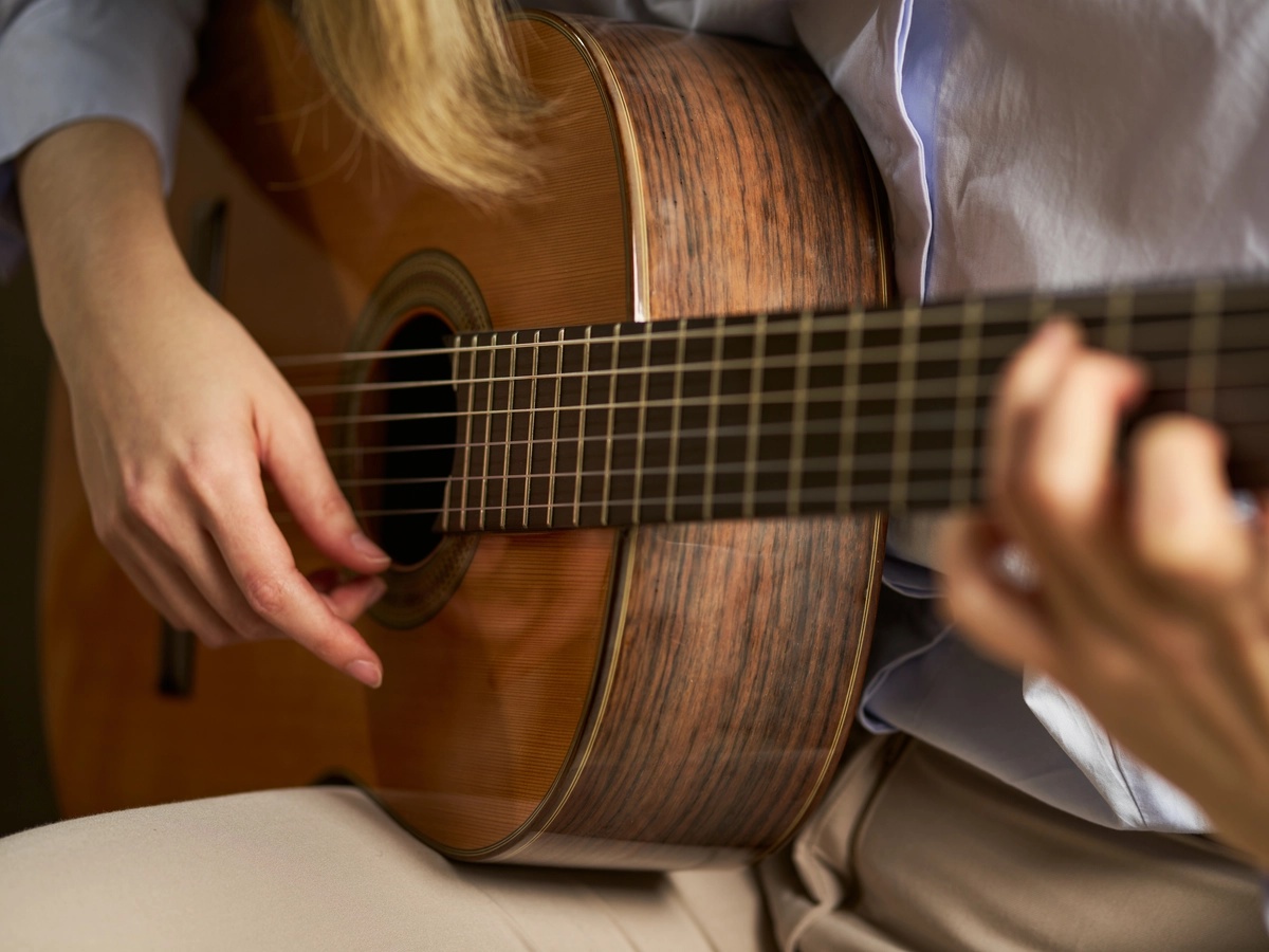 Experiential Therapy: Person strumming a guitar