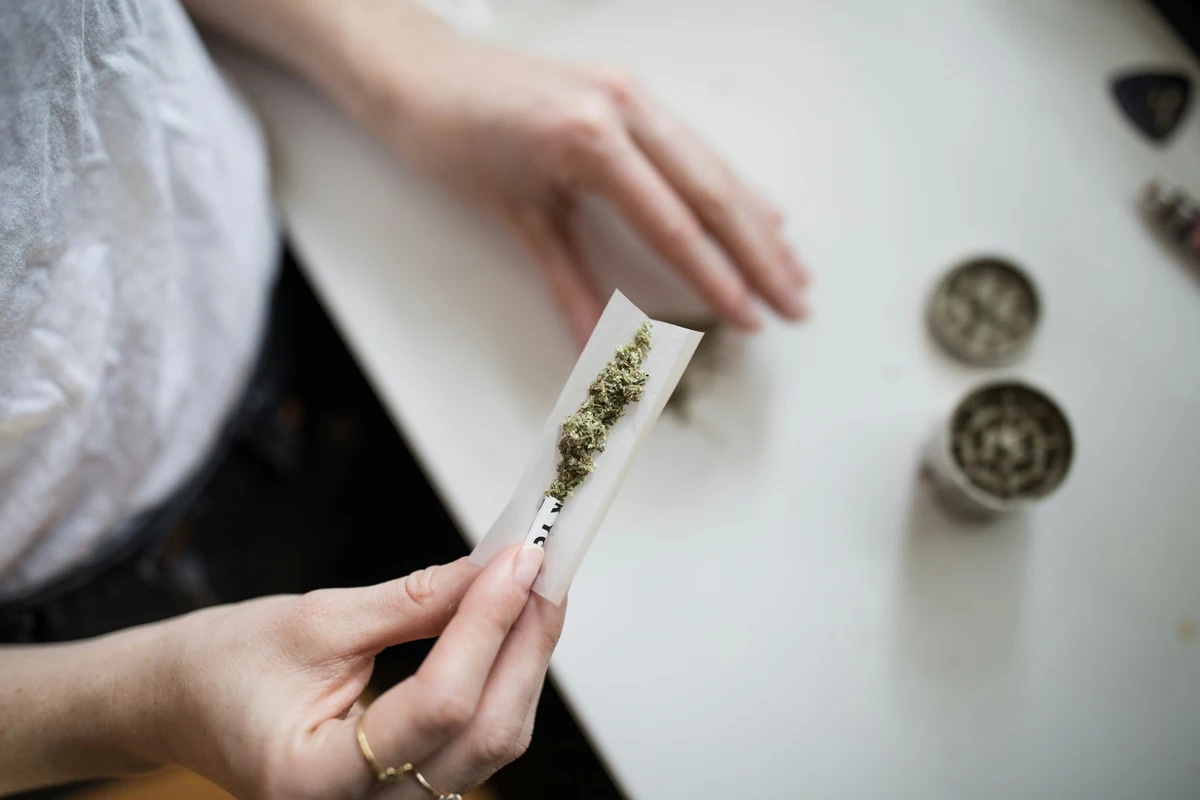 Marijuana Addiction: Woman rolling a marijuana joint