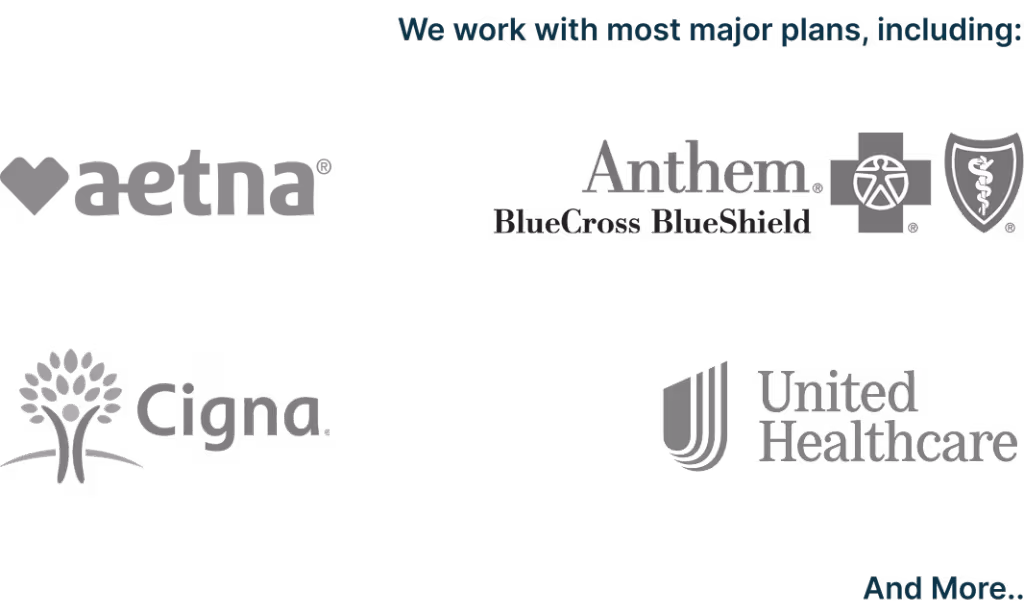 Bright orange county rehab therapy room with therapist looking at patients charts happily.
